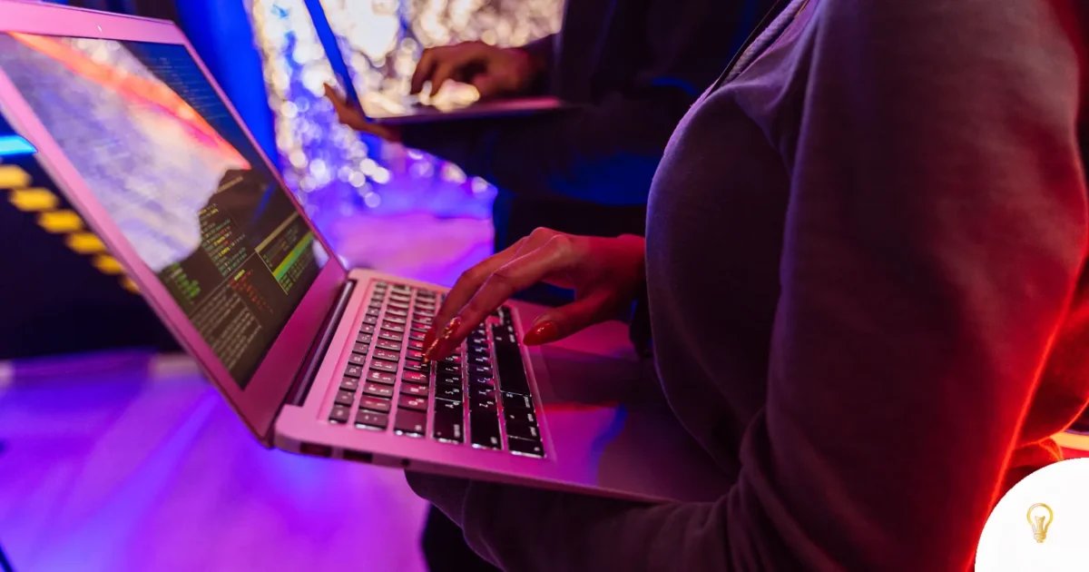 Two professionals analyzing data on laptops with colorful lighting, focusing on cybersecurity details, featured image for 1Password for Agents: Let AI Log In Without Your Passwords