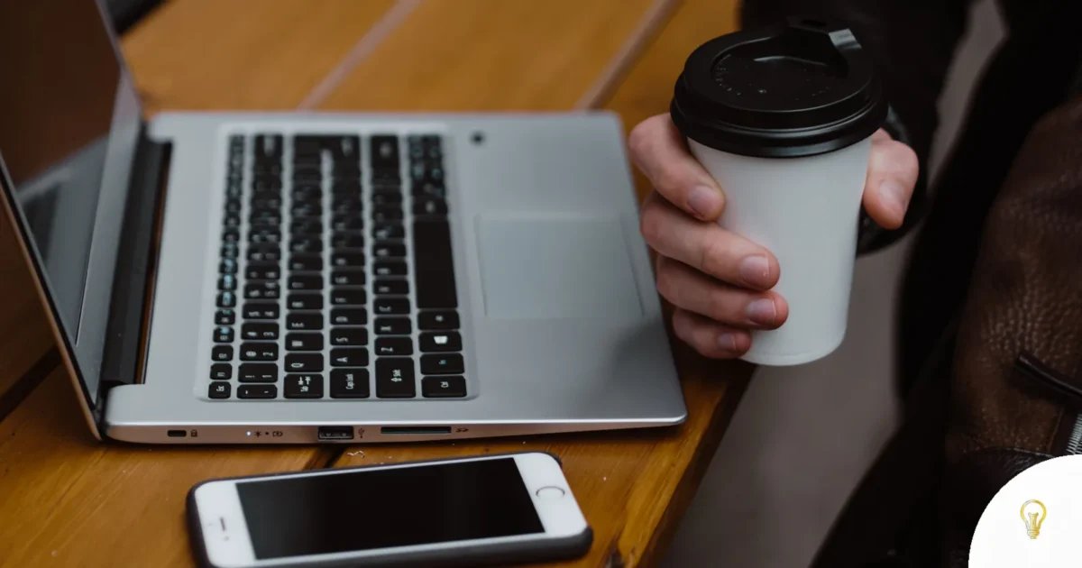 Cozy workspace setup with laptop, smartphone, and coffee on a wooden desk, featured image for Claude Duet: 6 Hints to Put Anthropic's Agent to Work